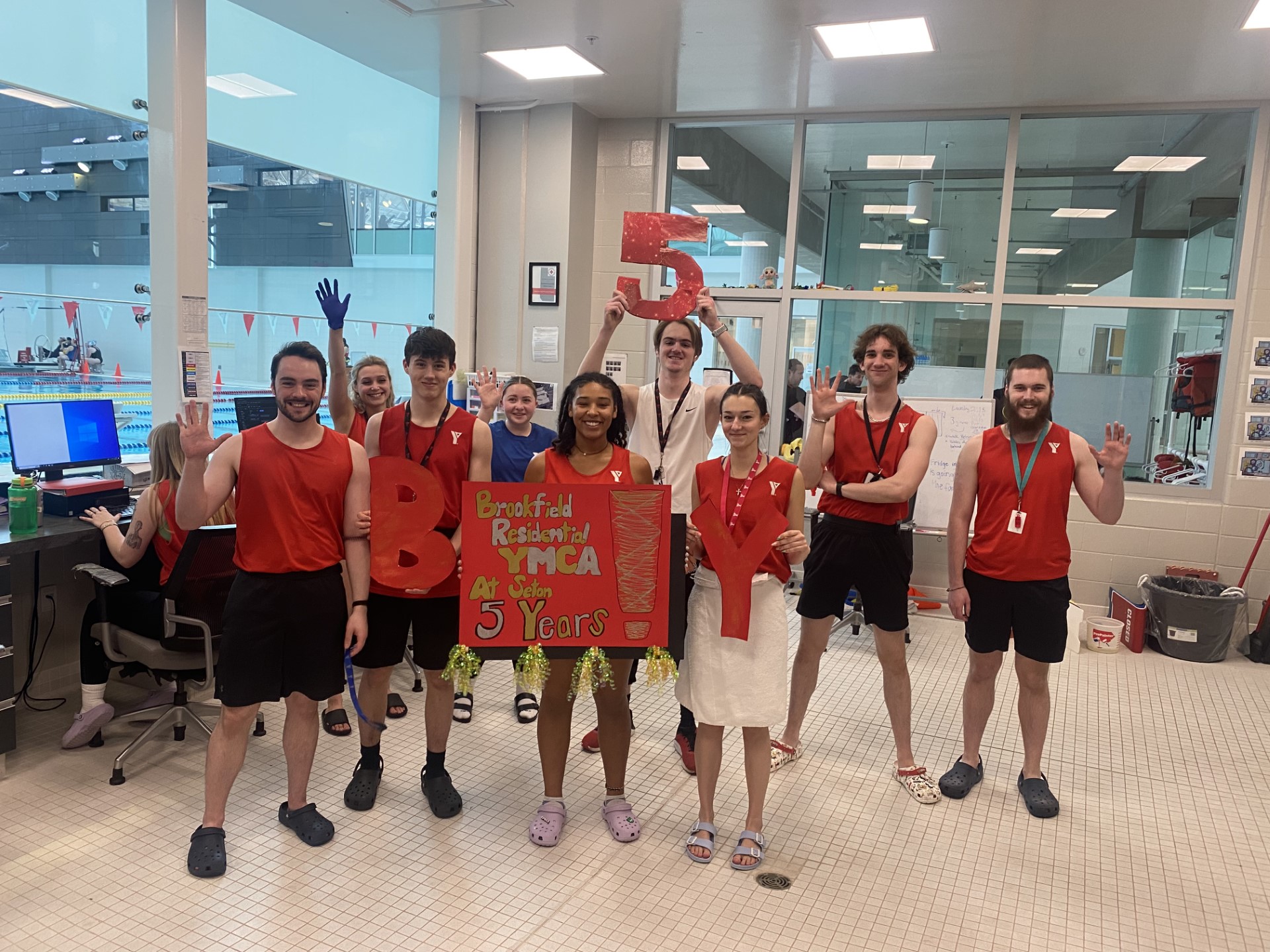 A group of aquatics staff at Brookfield Residential YMCA celebrate 5 years