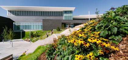 exterior of Seton YMCA building with flowers in foreground