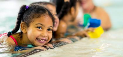 little girl smiling in pool