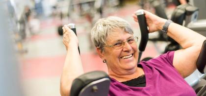 older woman using exercise machine