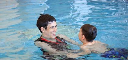 swim instructor with child in pool