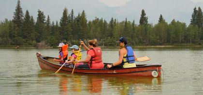 family in a canoe on the lake