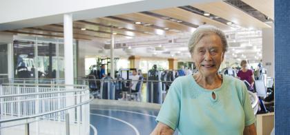 older woman smiling on indoor track