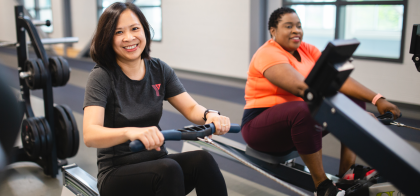 YFit - Certified trainer and a client on the weight floor