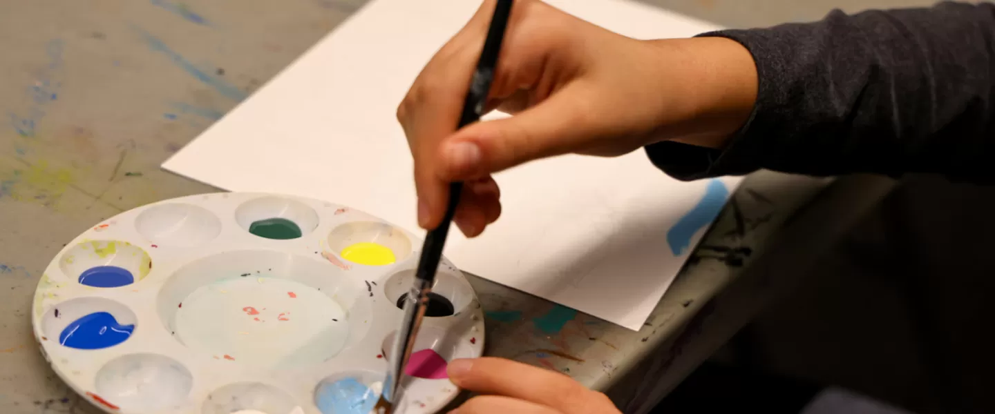 hands holding paint brush