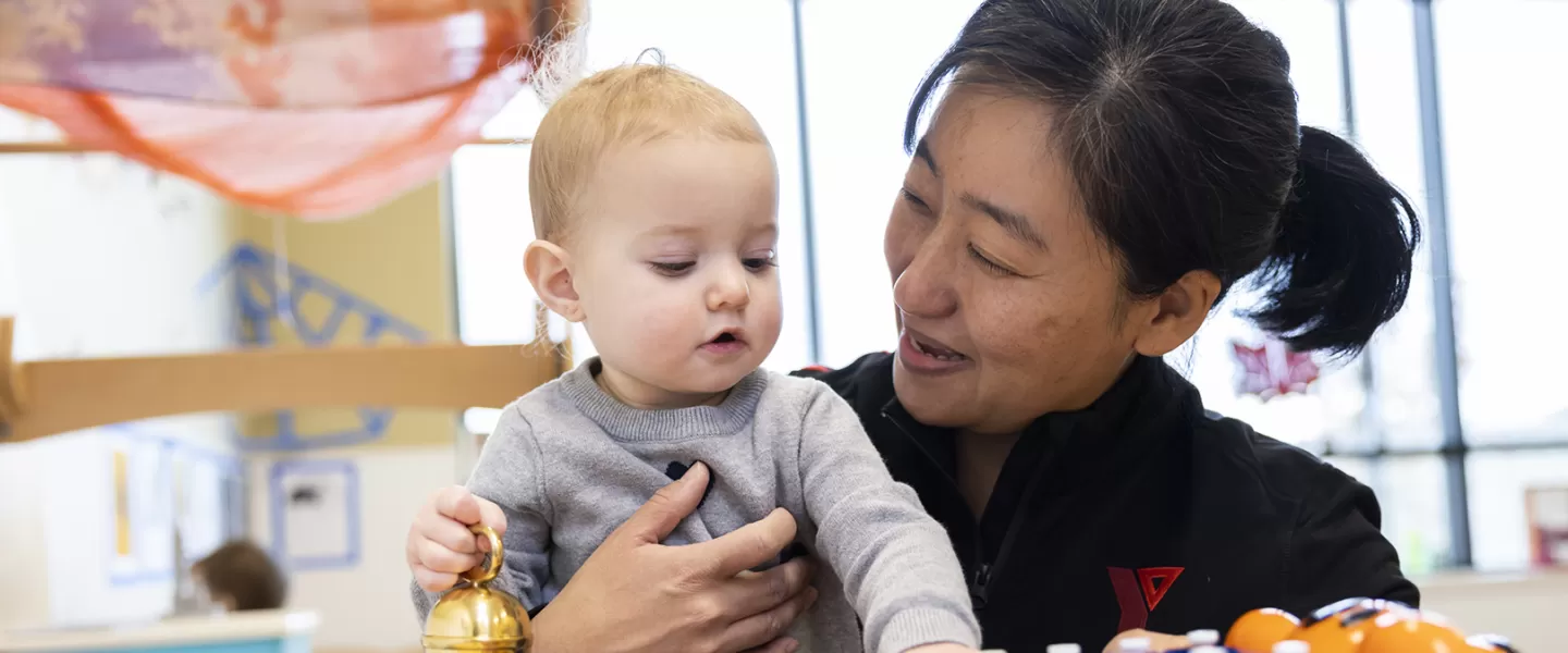 young child hugging educator