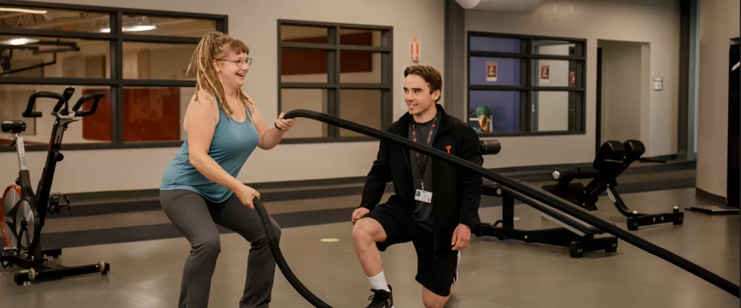 YFit - Certified trainer and client on weight floor