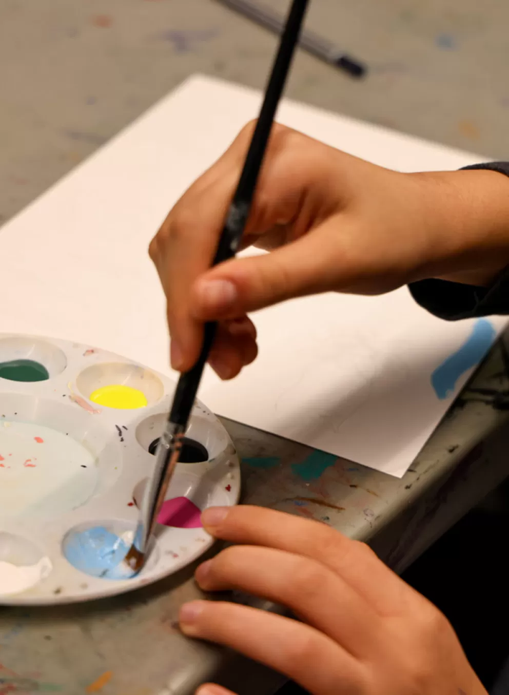 hands holding paint brush