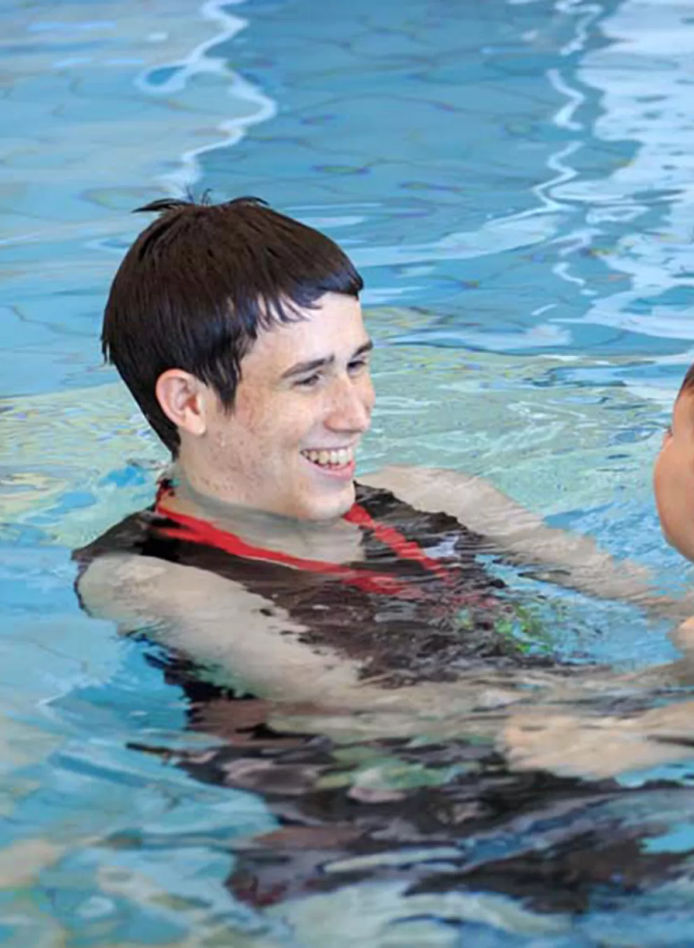 swim instructor with child in pool