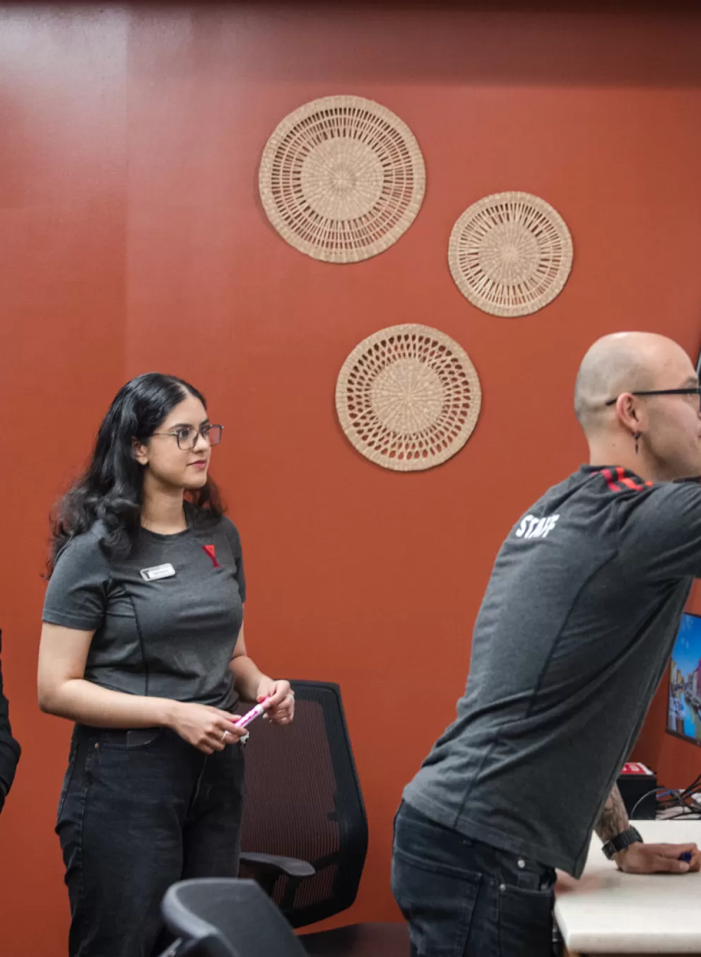 YMCA staff writing on a white board