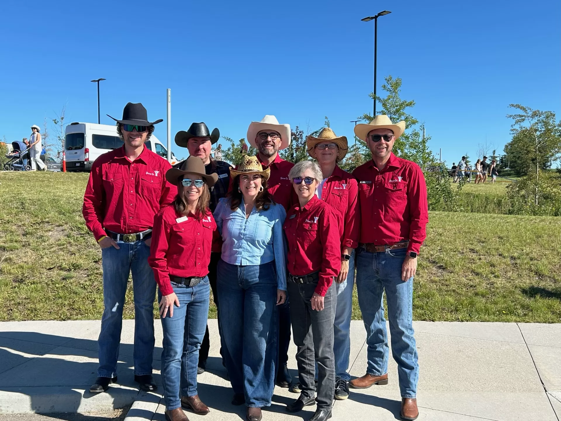 A group of senior leadership pose at a Stampede Breakfast