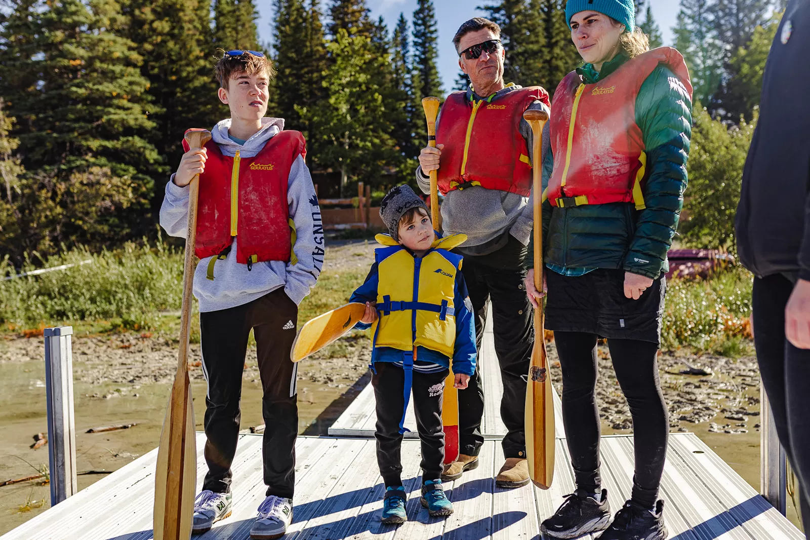 A group of people in lifejackets pose for a photo at Camp Chief Hector