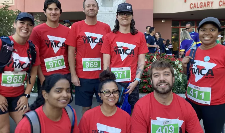 Team YMCA is ready to hit the 5K run, wearing their red YMCA shirts and runner numbers.