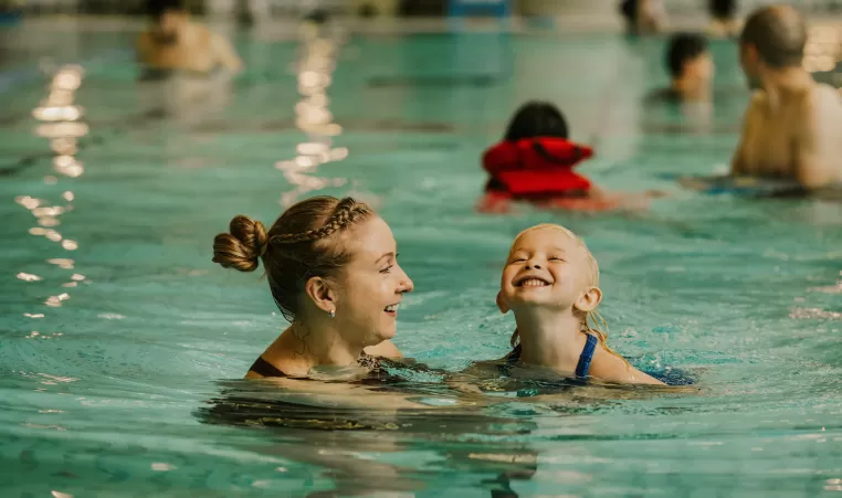 Mother and child swimming in pool