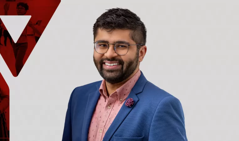 Zain Velji poses for a headshot on a graphic background