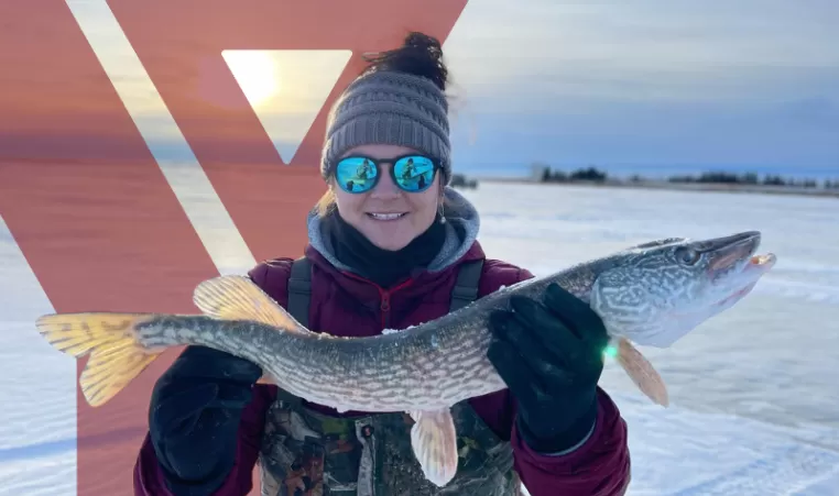 Tamara Lee holds up a fish she caught