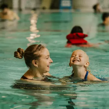 Mother and child swimming in pool