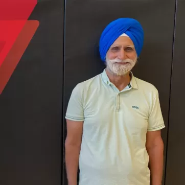  Mukinderpal Uppal smiles in front of a black gym mat background