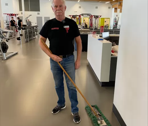 A weight floor volunteer helps maintain Remington YMCA