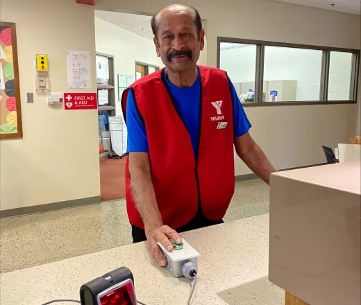A customer service volunteer is ready to let the next guest through at Saddletowne YMCA