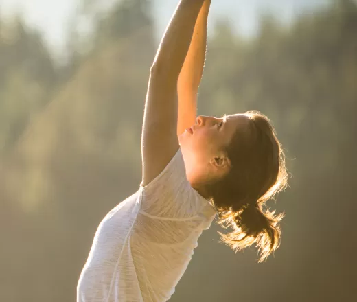 A woman does yoga outside