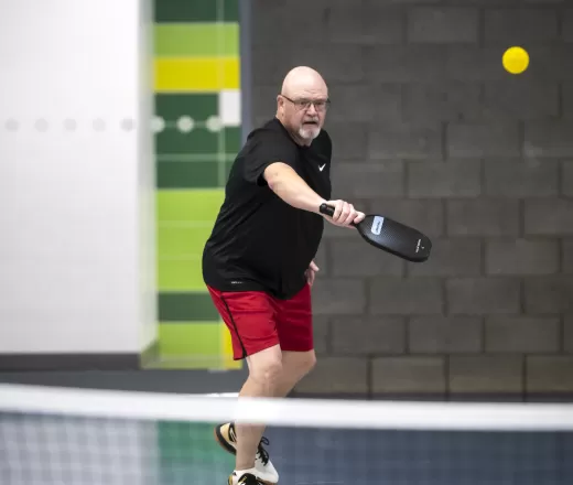 A man plays pickleball