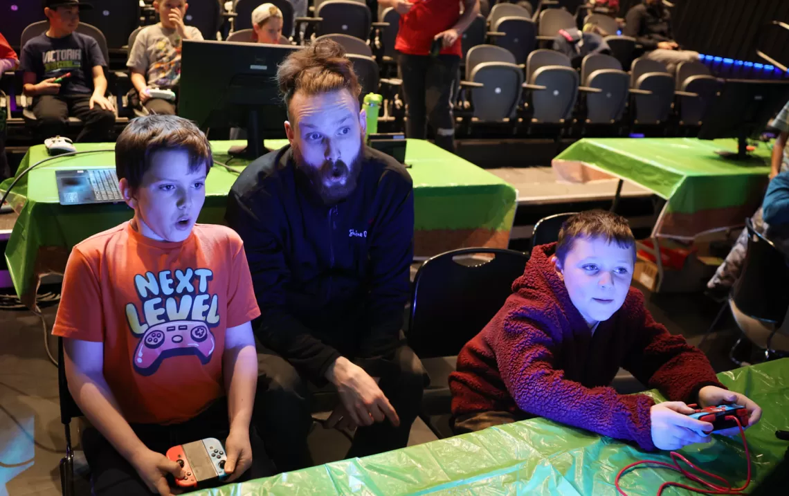 Youth and instructor playing video games