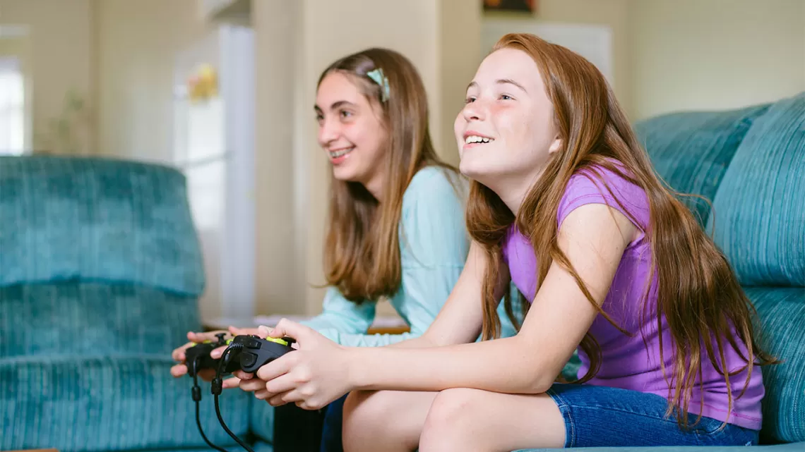 Youth playing video games at home