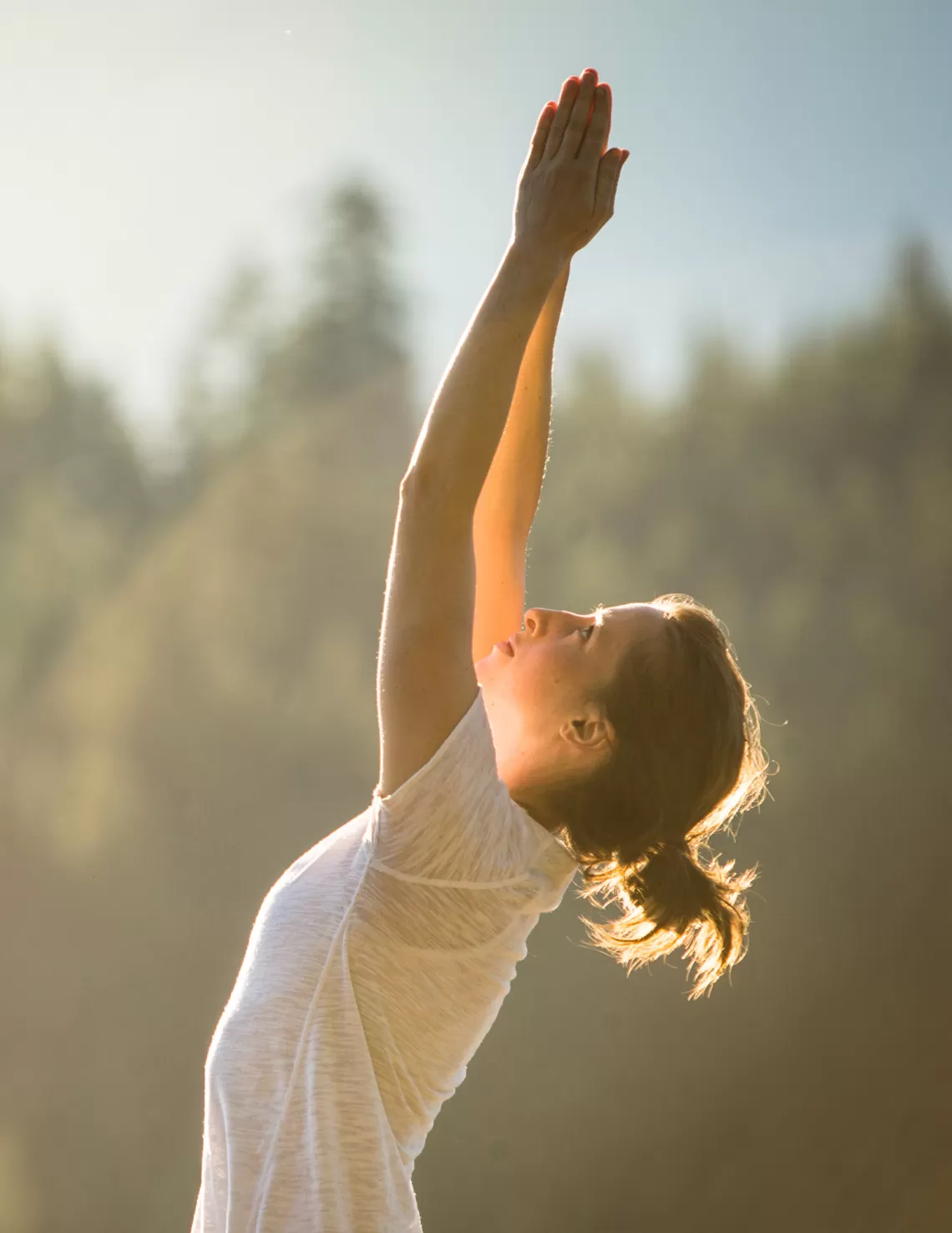 A woman does yoga outside